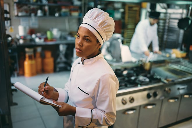 African American chef checking kitchens supplies while working at restaurant