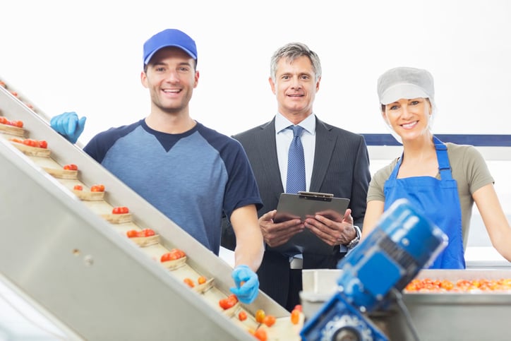 Portrait of supervisor and workers in food processing plant
