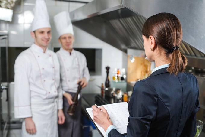 Restaurant manager briefing to his kitchen staff in the commercial kitchen