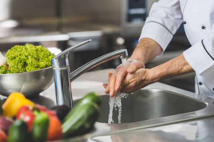 chef washing hands at restaurant kitchen