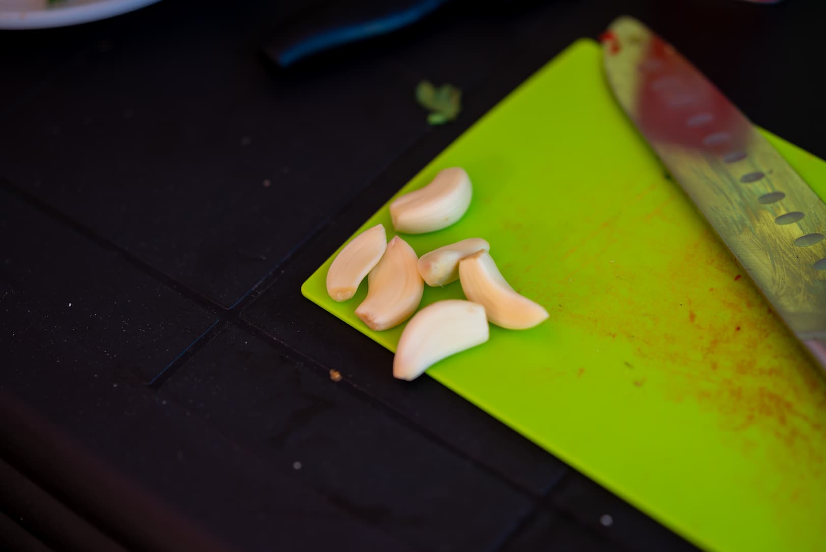 chopping vegetables on a green chopping board